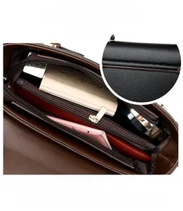 Detail view of large capacity tote bag with multi-layer zipper compartments and pebble grain