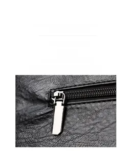 Close-up of black lychee grain leather texture and durable silver metal zipper detail