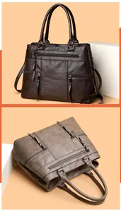 Detail view of large capacity vintage soft leather tote with multiple zippers and straps