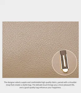 Close-up of pebble leather texture and gold metal hardware on women's shoulder bag