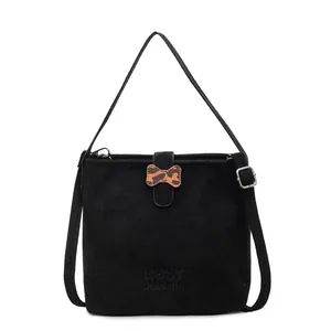 Elegant black suede bucket bag with leopard bow detail and silver shoulder strap