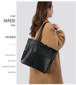 Close-up of soft black PU leather tote bag with stylish pleated texture and dual front pockets