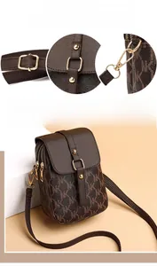 Detailed view of dark brown monogram crossbody mini bag with gold hardware and dual zippers