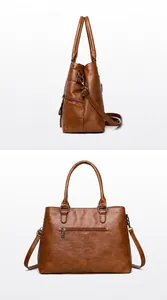 Macro view of textured brown leather handbag with side zippers and adjustable strap