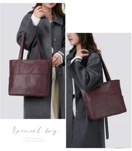 Detail of dark burgundy faux leather tote bag with functional stitching pockets and texture