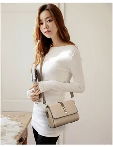 Detail of soft khaki leather crossbody bag with lychee texture and metal buckle