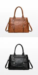 Detail view of large capacity faux leather tote bags in brown and black with zipper pockets