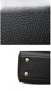 Detail of black lychee grain leather texture and metal protective base studs on handbag