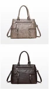 Detail view of large grey and brown leather tote bags with multiple zipper pockets