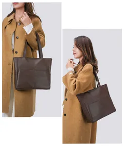 Detail of dark brown tote bag with vintage leather texture and vertical stitching
