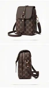 Detail showing dark brown mini crossbody bag with golden hardware and adjustable strap