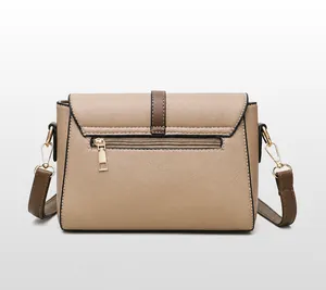 Detailed back view of a beige pebble leather shoulder bag with dark brown trim and gold zip