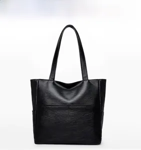Detailed front view of black large tote bag with lychee texture and shoulder straps