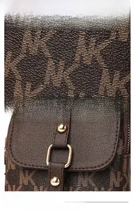 Detailed view of textured PVC handbag fabric with NK logo print and golden metal hardware