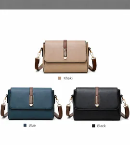 Detail view of khaki blue and black leather crossbody bags with metal lock decorations