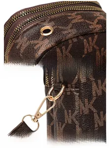 Detailed close-up of metal headphone port and hardware hooks on a brown crossbody bag