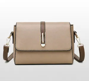 Close-up of khaki pebbled faux leather shoulder bag with gold metal buckle and strap detail