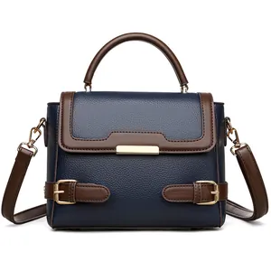 Deep blue and brown leather tote bag with gold metal accents and detachable strap