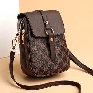 Classic brown crossbody phone bag with MK monogram print and gold zipper details