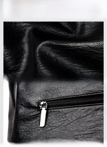 Close-up of black lychee grain leather texture and durable silver metal zipper puller