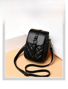 Detail of black quilted crossbody phone bag with polished faux leather and gunmetal hardware