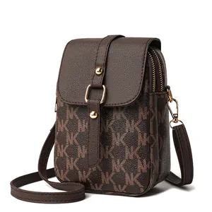 Classic dark brown monogram mini crossbody bag with gold buckle and adjustable strap