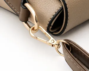 Close-up of litchi texture leather and premium gold-plated hardware on a shoulder bag