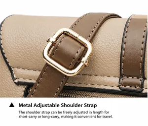 Detail of adjustable golden metal buckle and stitching on khaki leather shoulder strap