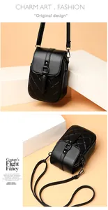 Detail view of black quilted crossbody phone bag with multi-zipper layers and metal clasp