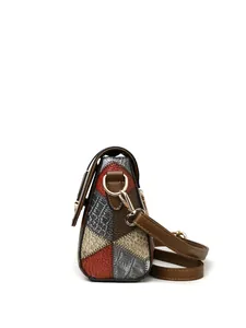 Detail of multi-color patchwork shoulder bag with textured faux crocodile leather and gold hardware