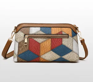 Back view of bohemian crossbody bag showing colorful geometric patchwork and zip pocket