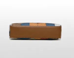 Detail view of the colorful pebbled leather handbag bottom with reinforced stitching