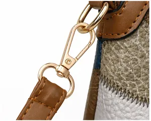 Detail of bohemian crossbody bag showing golden buckle and multi-color leather stitching