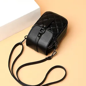 Quilted black leather phone bag with dual zippers and decorative metal buckle strap