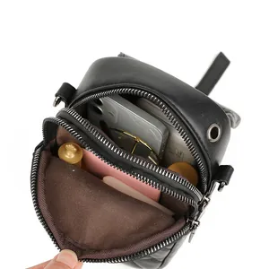 Black quilted mini crossbody phone bag with dual zippers and spacious inner compartments
