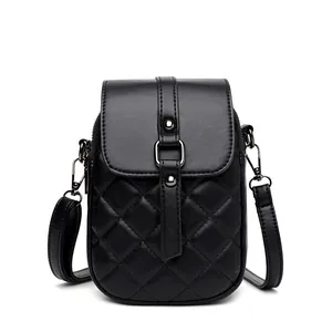 Minimalist black quilted cell phone crossbody bag with adjustable shoulder strap and studs