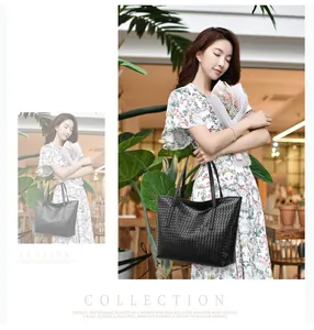 Detailed close-up of premium woven black leather tote bag with geometric grid texture