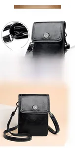 Detail of the detachable shoulder strap buckle and sunflower metal clasp on black mobile bag