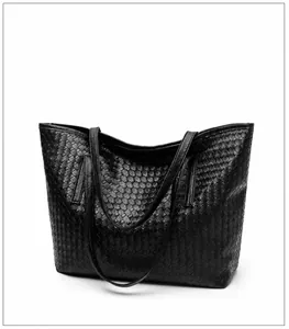 45-degree side view of a black woven tote bag showing premium texture and double straps