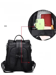 Macro view of anti-theft back zipper pocket on black woven PU leather backpack