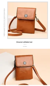 Close-up of caramel PU leather phone bag with sunflower buckle and white stitching