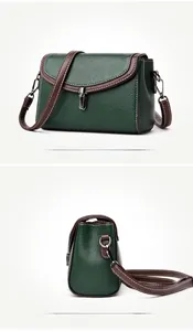 Detail view of dark green pebbled leather bag with contrast stitching and silver lock