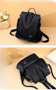 Detailed close-up of a black woven texture backpack with silver shield logo and dual zippers