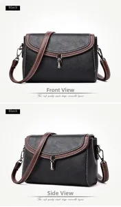 Detail of black pebbled leather crossbody bag with brown trim and contrast stitching