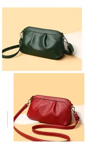 Detailed close-up of ruched dumpling crossbody bags in soft pebbled leather with strap
