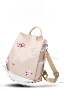 Detail of lightweight beige backpack with floral embroidery and side pocket