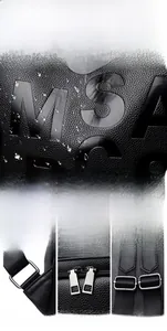 Macro detail of black litchi grain leather texture and high-quality silver hardware buckles