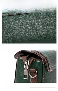 Detailed close-up of dark green lychee grain leather with white stitching and metal zipper