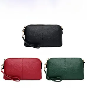 Detailed comparison of leather wristlet purses in black, claret, and green with gold zippers