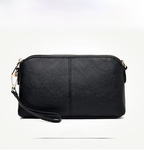 Front view of black litchi pattern leather clutch with gold zipper and wrist strap